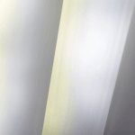 Close-up view of galvanized steel sheets with a reflective zinc coating, used in industrial manufacturing.