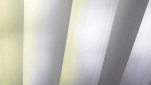 Close-up view of galvanized steel sheets with a reflective zinc coating, used in industrial manufacturing.