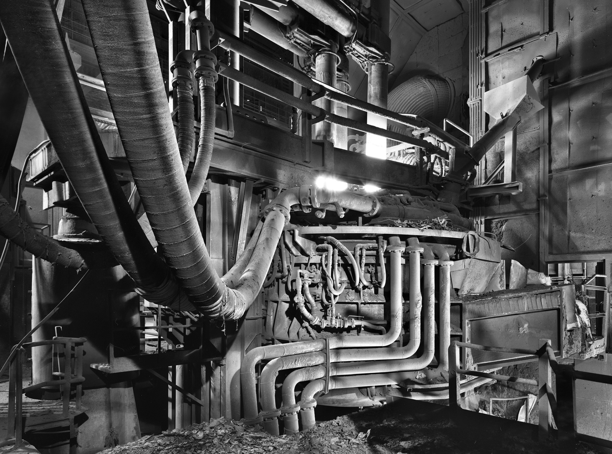 Industrial machinery with interconnected pipes and metallic structures, showcasing a complex engineering setup